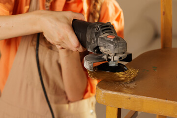 Hand Sanding Wooden Chair with Grinder during Restoration Process