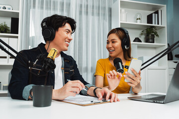 Smiling radio influencer hosts wearing headphones with channel social media online live streaming...