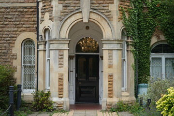 Arnot Hill Park, Nottingham, England - July 23 2025: Historic stone arch entrance with ivy and chandelier captured in Nottingham's historic park.