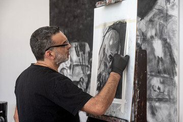 Artist in his painting studio, in Villa Giardino, Córdoba, Argentina.
