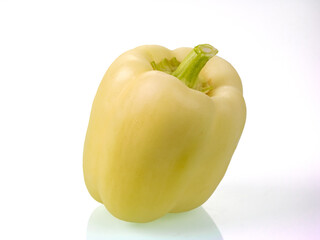 Fresh green bell pepper with reflections on a white background