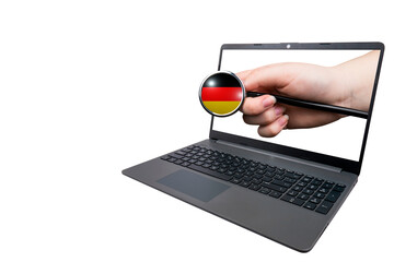 A hand with a medical stethoscope, the top of which is made in the shape of the German flag, sticks...
