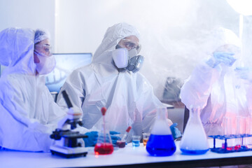 A frontline team of scientists in full protective hazmat suits follows strict protocols in a...