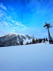 Snowy Ski Slope with Chairlift on a Clear Winter Day