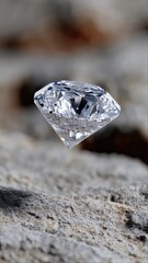 Close-up of sparkling diamond on gray stone surface