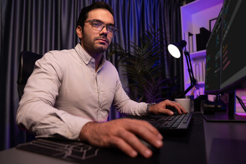 Working smart IT developer analyzing data software development on two pc screen, creating...