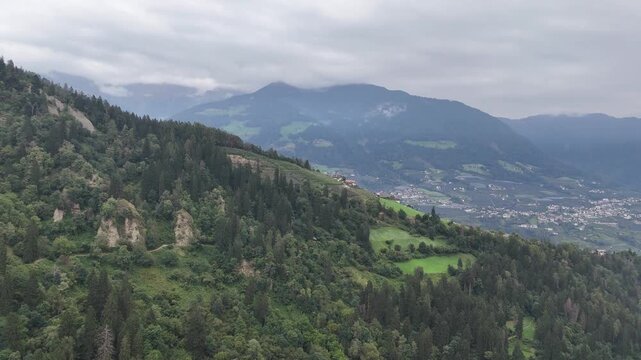 Flight towards mountain panorama with mountain Ifinger and clouds in South Tyrol, Italy
