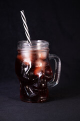 A skull-shaped mug filled with a blood-red drink