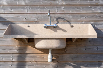 outdoor sink on a wooden wall at a campsite