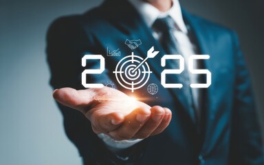 Concept of setting business goals for 2025. A businessman holds a virtual target icon representing new year strategy, corporate vision, and future success.
