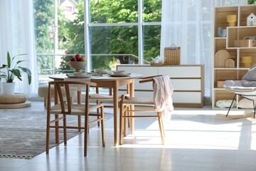 Stylish table setting, chairs and decor in dining room. Interior design