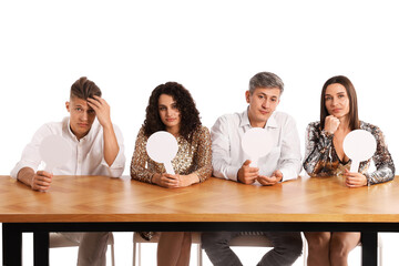 Panel of judges with blank score signs at table on white background