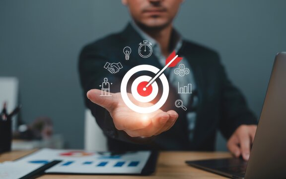 Achieving Business Goals A Man Holding a Target Symbolizing Success and Strategy