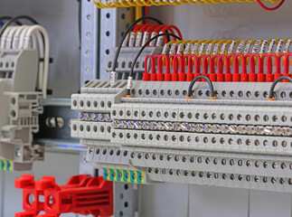 Electrical screw terminals for connecting wires in an electrical switchboard. Soft focus. Close-up.