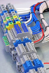 Electrical screw terminals for connecting wires in an electrical switchboard. Soft focus. Close-up.