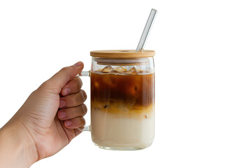 Hand holding a glass mug filled with iced coffee and a metal straw with a wooden lid on top on transparent background