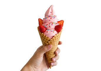 A hand holding a waffle cone filled with pink frozen yogurt and strawberry slices and colorful sprinkles on transparent background
