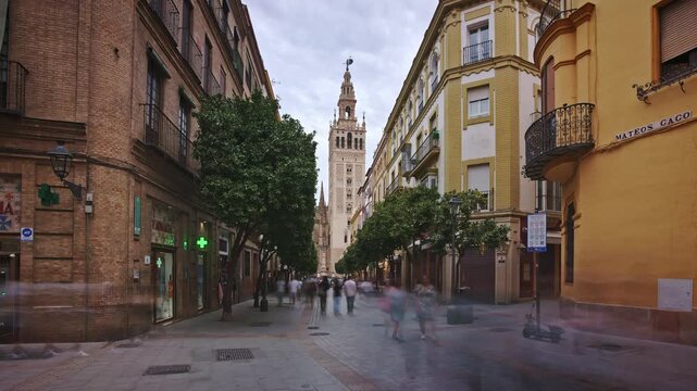 Timelapse on a pedestrian street in Seville&rsquo;s city center with Giralda in the background and people walking