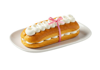 Delicious pastry filled with cream and tied with a pink ribbon on a white plate isolated on transparent background