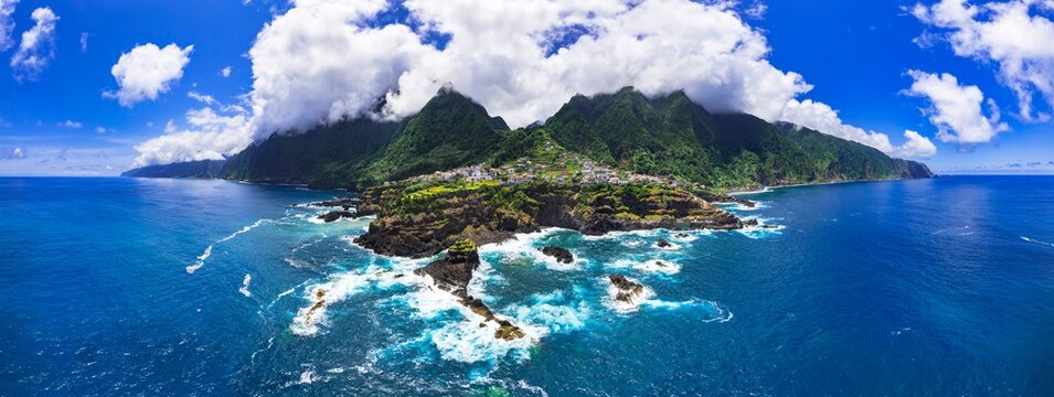 Madeira island beautiful nature scenic places. Stunning Seixal coast and village, aerial drone view of rocky coast and natural lava swimming pools. Portugal travel
