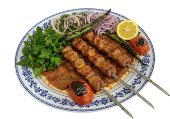 A plate of grilled meat skewers with vegetables and lemon slice on a decorative floral plate on transparent background
