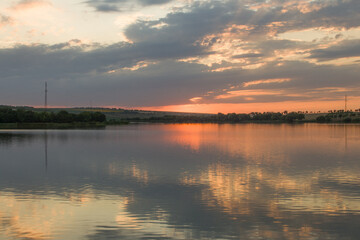 A body of water with trees in the background