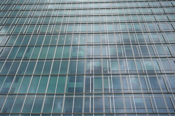 Glass panels repeat like code. Light patterns shift behind symmetry. Each window hides another...