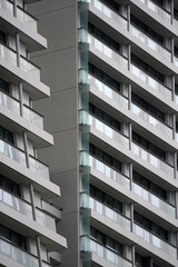 Modern high-rise architecture with repeating balcony patterns creates a strong geometric rhythm....