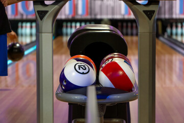 Close up of the balls coming out from bowling return machine