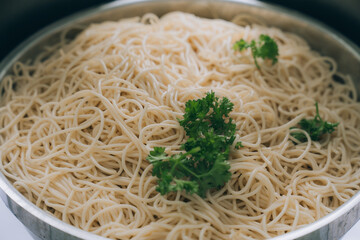 Noodle Dish:  A close-up shot revealing a generous serving of perfectly cooked noodles, garnished with fresh, vibrant parsley, inviting viewers into a world of culinary delight and exquisite flavors.