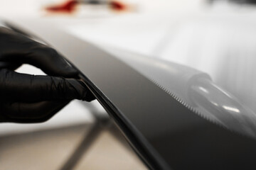 Inspecting the windshield edge before applying adhesive for seamless car glass installation....