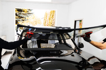 New Windshield installation process. Windshield Installation Using Suction Lifters. Two technicians...