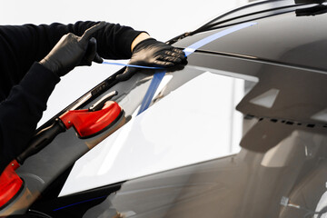 Windshield replacement using lifting tools that grip glass securely. Windshield technicians rely on...