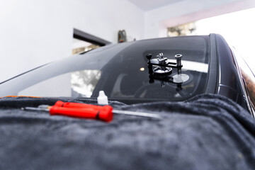 Resin repair on windshield using injector application to restore structural clarity. Windshield...