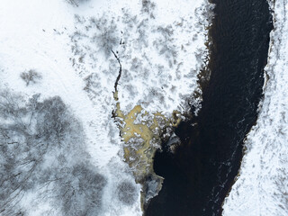 Aerial top down view of beautiful frozen Pirita river on a cloudy winter day. Lasnamae district...