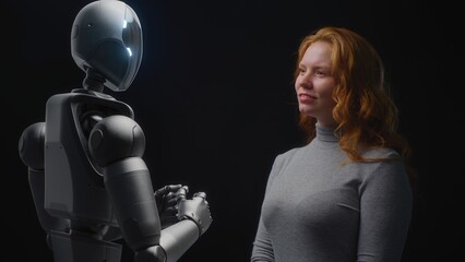 Futuristic Human-Machine Concept: Visualization of Young Woman Speaking with Advanced Humanoid Robot. People and Robots Working Together. Collaboration Between Humanity and Artificial Intelligence.
