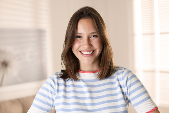 Portrait of smiling teenage girl at home - Powered by Adobe