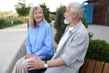 Lovely senior couple on bench in park