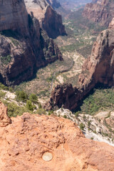 A USGS marker embedded in red stone marks the summit of Zion’s Observation Point above the green canyon below, June 5, 2021, Zion, UT
