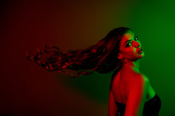 Photo of gorgeous lady model profile fluttering hair isolated multicolor disco red green neon light...