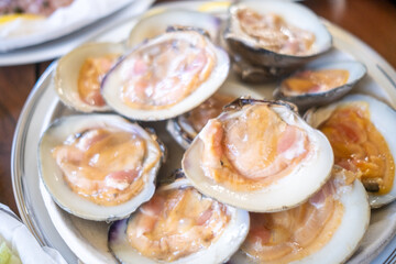 Close-up of freshly shucked oysters on the half shell reveals their briny texture and translucent flesh, served chilled at a San Francisco seafood restaurant