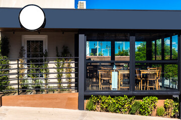 Blank circular shop signboard mockup for design. Street hanging sign board for logo presentation. Cafe restaurant or bar badge black white round, in Brazil