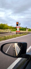 Stopping at a railroad crossing. Red traffic light and view from the car window