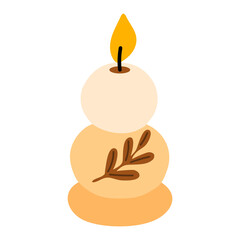 Stacked round beige candles with autumn leaf decoration