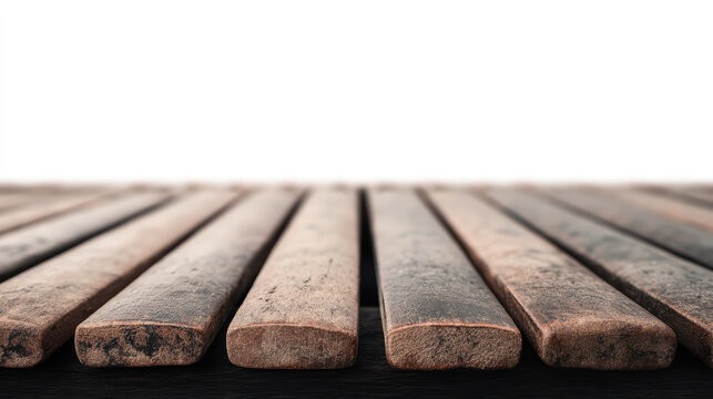 Close-up of weathered wooden planks aligned side by side, showing texture and grain with a blurred white background.