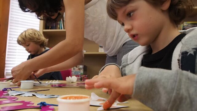Mother and Sons Doing Arts and Crafts Together at Home