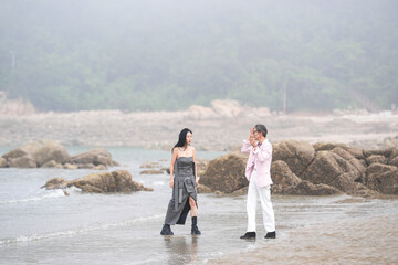 In June 2025, a Korean man and woman in their late fifties are running at full speed along the...