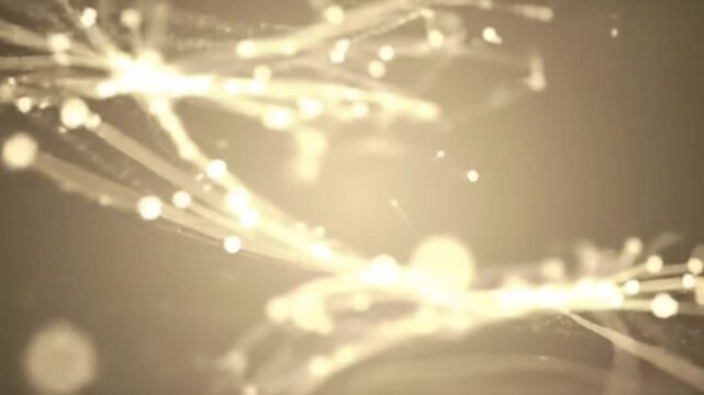 Golden light streaks and sparks radiate in a mesmerizing abstract pattern against a dark backdrop with a warm glow