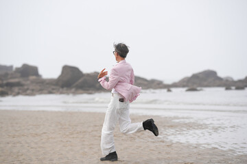 In June 2025, a Korean man and woman in their late fifties are running at full speed along the...