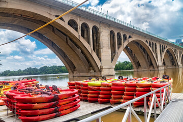 Stacked kayaks, silent river
Bright colors contrast with the gray stone and sky.